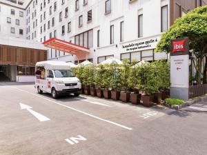 a white truck parked in front of a building at Ibis Bangkok Sukhumvit 4 in Bangkok