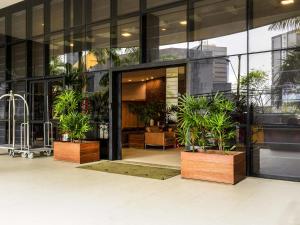 a building with potted plants in front of it at Mercure Salvador Boulevard Hotel in Salvador