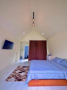 a bedroom with a large bed and a red curtain at Diiza Glamping Tawangmangu in Tawangmangu