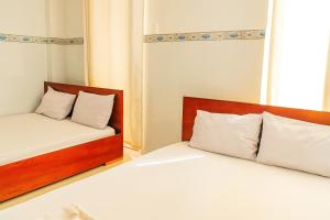 two beds sitting next to each other in a room at Nam Dương 1 Hotel in Phan Rang–Tháp Chàm