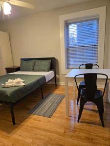 a room with a bed and a table and chair at Grand House in Chicago +13 photos