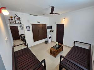 a living room with two chairs and a table at Guruvayur Nest Homestay in Guruvāyūr