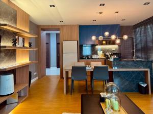 a kitchen and dining room with a table and chairs at The Prestige Living Bangkok at Sathorn-Chan in Bangkok