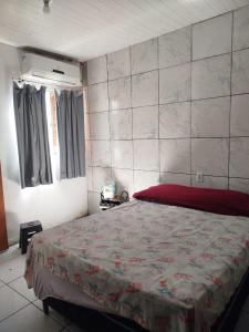 a bedroom with a bed with a red bedspread at Casa Cop 30 - Belém in Belém