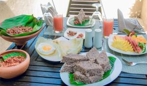 a table with plates of food on top of it at Nishadi Holiday Inn Kataragama in Kataragama