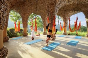 a group of people doing yoga in a pavilion at Padma Resort Ubud in Payangan
