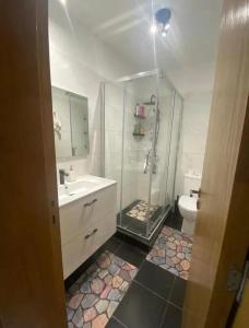a bathroom with a shower and a sink and a toilet at Beach Appartement & Résidence Luxury Aourir in Agadir