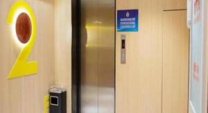 a elevator in a building with a sign on it at IU Hotels Beijing Changping Bei Qijia in Changping
