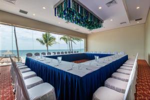 a long table with white chairs and a blue table cloth at Crown Paradise Club Puerto Vallarta All Inclusive in Puerto Vallarta +73 photos