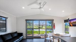 a living room with a couch and a table at Colac Colac Caravan Park in Corryong