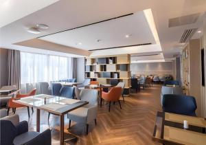a restaurant with tables and chairs in a room at Echarm Hotel Changsha Xiangya Fushan in Changsha +138 photos