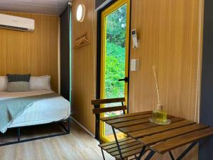 a room with a bed and a table and a window at Montville Retreat by Tiny Away in Flaxton +28 photos