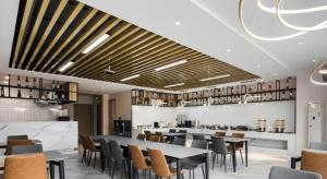 a restaurant with tables and chairs and a bar at GEM Hotel Changzhou Xuejia'aoyuan North High-Speed Railway Station in Changzhou