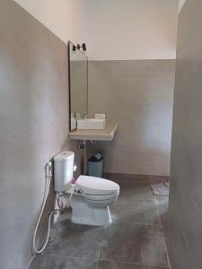 a bathroom with a white toilet and a sink at Luka's Place - 1 bedroom in Cemagi