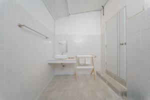 ein weißes Badezimmer mit Waschbecken und Spiegel in der Unterkunft Three COCO Villa Aonang Krabi in Ao Nang Beach