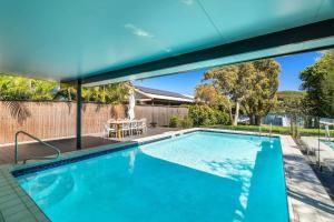 a swimming pool in the backyard of a house at Casa Di Angelina By Coast Hosting in Blackwall