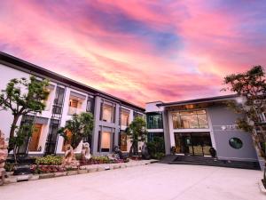 a building with a cloudy sky in the background at TEVA Valley Resort in Chiang Rai