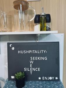 a sign that is on a shelf with a plant at Tranquility Ranch by Tiny Away in Wolfdene
