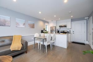 eine Küche und ein Wohnzimmer mit Tisch und Stühlen in der Unterkunft Brand New Stylish 2 bedrooms Suite in Shaughnessy in Vancouver