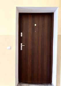 a wooden door in a building at Kotlarska 39 Apartment - Self Check-In 20h in Wrocław