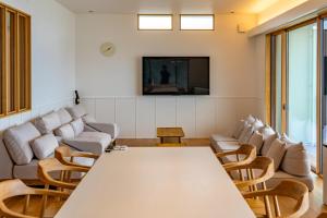 a conference room with a table and chairs and a tv at Nagisato Villa Clover in Takamatsu +44 photos