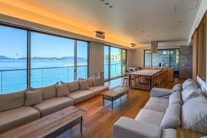 a large living room with a large couch and a table at Nagisato Villa Clover in Takamatsu