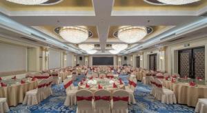 a large banquet hall with white tables and chairs at Nanjing Grand Da Qiao Hotel in Nanjing