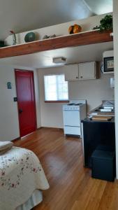 a room with a red door and a kitchen at Jones Cabin in Friday Harbor