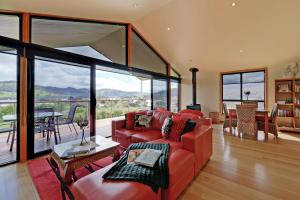 a living room with a red couch and a table at Moon River in Gardners Bay