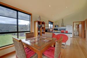 a kitchen and dining room with a table and chairs at Moon River in Gardners Bay