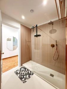 a bathroom with a shower with a glass wall at Merulana 13 in Rome