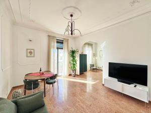 a living room with a television and a table at Merulana 13 in Rome