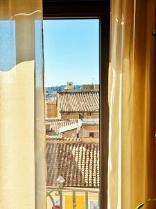 a window with a view of a city at Merulana 13 in Rome