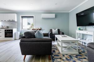 a living room with a couch and a table at Melrose Retreat with Court Access in Melrose