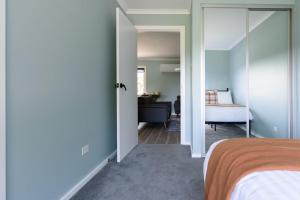 a bedroom with a bed and a living room at Melrose Retreat with Court Access in Melrose