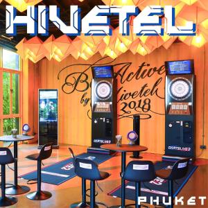 a room with tables and chairs and two ticket machines at Hivetel in Chalong 