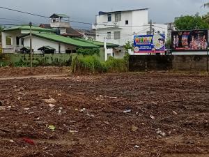 a dirt road with buildings in the background at Pirivena Garden Resort - AC Units, Kitchen, Attached Bath Room, & WiFi in Boralesgamuwa