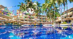 a swimming pool with chairs and umbrellas in a resort at Mexican Experience by Villa del Palmar in Puerto Vallarta