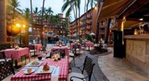 a restaurant with tables with red and white table cloth at Mexican Experience by Villa del Palmar in Puerto Vallarta