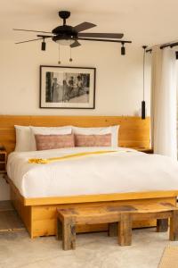 a bedroom with a large bed with a wooden headboard at Aviva Hotel in Tzununá