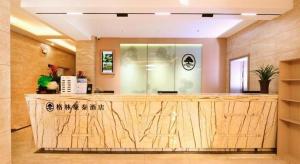 a lobby with a reception desk in a building at GreenTree Inn Jiangsu Xuzhou Western 3rd Ring Road Xiyuan Express Hotel in Xuzhou