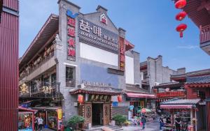 a street in an asian city with a building at James Joyce Coffetel Xian Dayanta Metro Station Branch in Xi'an