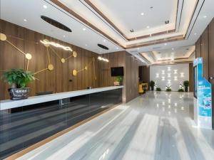 a lobby with a dance floor and a television at GYA Changzhou Wujin District Hutang New Era Furniture Plaza Hotel in Changzhou