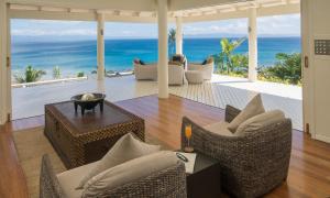 a living room with a view of the ocean at Raiwasa Grand Villa in Matei