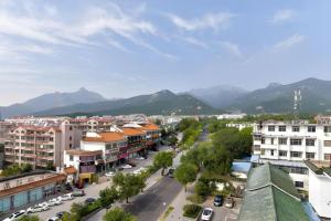 an aerial view of a city with mountains in the background at Yitel Tai'an Taishan Hongmen Daimiao in Tai'an