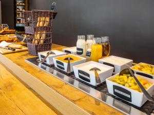 a buffet with food and drinks on a table at ibis budget Paris Porte de Montreuil in Montreuil