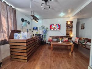 a coffee shop with a counter and a table at Alec Lodge in Coron