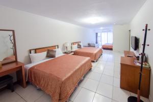 Voodi või voodid majutusasutuse Palm Tree Hotel Kenting toas