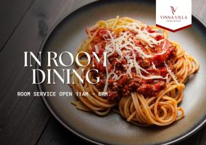 a plate of spaghetti with meat sauce and cheese at Vinna Villa Seminyak in Kerobokan