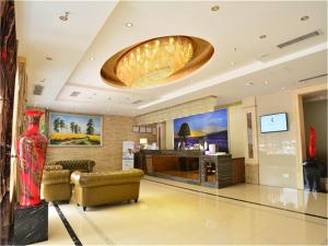 a lobby with a red vase and a large ceiling at Lavande Hotel Wuhan Railway Station in Wuhan